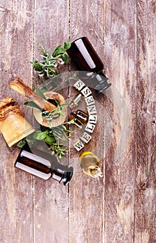 Homegrown and aromatic herbs with rosemary and basil. Wellness sign with wooden cubes