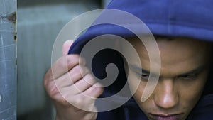 Homeless afro-american boy wearing hoodie, depressed of being lonely, racism