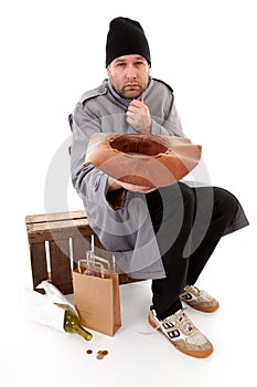 Homeless beggar holding hat for money