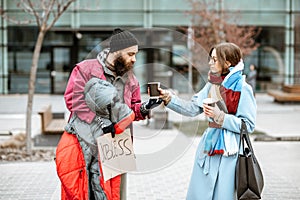 Homeless beggar talking with passing by woman