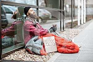 Homeless begging money near the business center