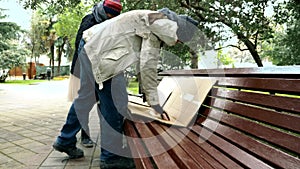 A homeless couple, a man and woman on a bench in a city Park