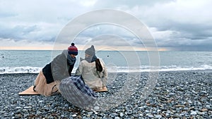 Homeless couple, man and woman, staying overnight by the sea