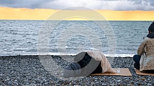 Homeless couple, man and woman, staying overnight by the sea