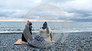 Homeless couple, man and woman, staying overnight by the sea
