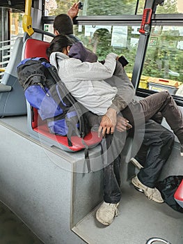 Homeless couple in public transport, sleeping