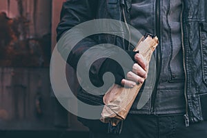 Homeless drunkard drinking alcohol next to old train wagon photo