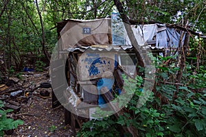 Homeless dweling. Small habitation made from garbage in dirty littered forest