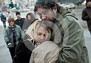 Homeless frozen couple embracing
