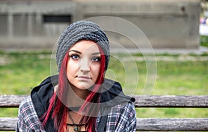 Homeless girl, Young red hair girl sitting alone outdoors with hat and shirt anxious and depressed after she became a homeless