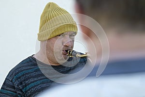 A homeless, hungry man greedily eats a piece of bread. Poverty, unemployment, hunger. Portrait