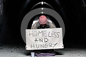 Homeless and hungry person begging