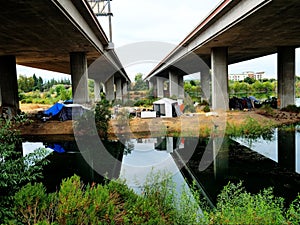 Homeless Island, with ugly encampments under highway overpass