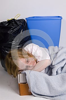 Homeless kid sleeping in a box