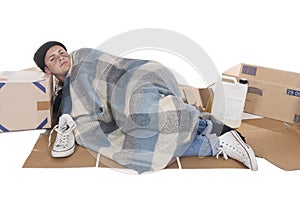 Homeless lying on cardboard