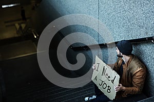 Homeless Man Asking For Job Sitting on Stairway Sidewalk