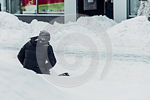 Homeless man begs for alms knees in the snow