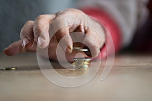 Homeless man counting Euro coins