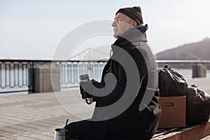 Homeless man having rest on the bench