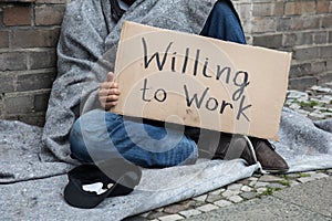 Homeless Man Holding Cardboard With Text Willing To Work