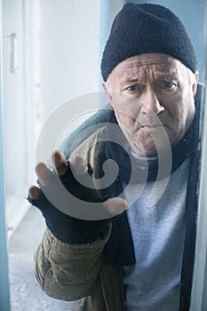 Homeless man looks out of the window photo
