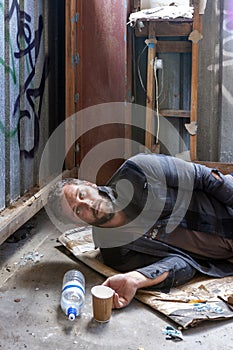 A homeless man lying on the ground