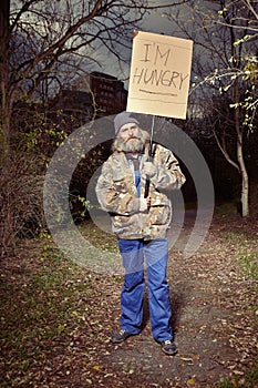 Homeless man in park asking for something to eat photo