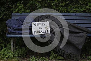 Homeless man on park bench