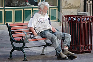 Homeless Man Sitting on a Park Bench on Stephen Avenue in Calgary Alberta