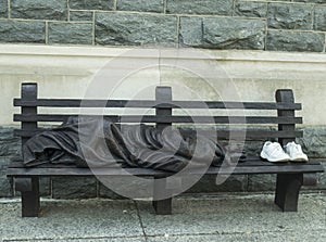 Homeless man sleeping on the bench photo