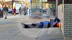 Homeless man sleeping on sidewalk