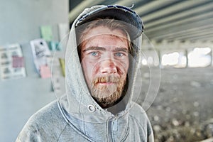 Homeless man in torn clothes