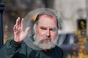 Homeless man waving