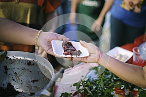 Homeless people are helped with food relief, famine relief : volunteers giving food to poor people in desperate need : The concept