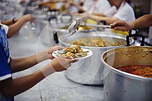 Homeless people and hungry people line up, asking for free food from volunteers