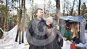 Homeless people are interviewed in the winter in the woods.