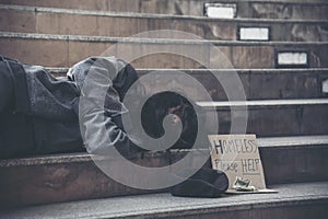 Homeless people poverty beggar man asking for money job and hoping help in helpless dirty city sitting with sign of cardboard box