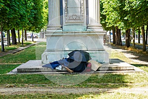 A homeless person in the park of Paris, France