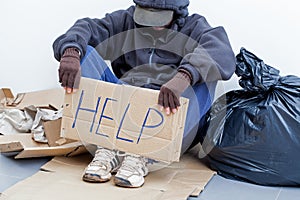 Homeless person sitting on the ground