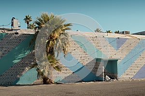 Homeless Person Sleeping Behind a Colorful Building