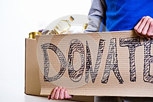 Homeless poor man holding carton board with word food DONATE