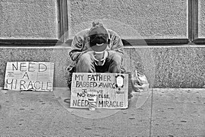 21.05.2016. Homeless poor person in front of Wall Street Stock Excange building ask help and money in Manhattan, New York City, US