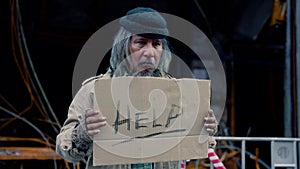 Homeless poverty man meet financial crisis standing holding sign help on street, dirty aged man with beard begging for money, no j