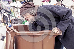 Homeless rummages in the dustbin of landfill