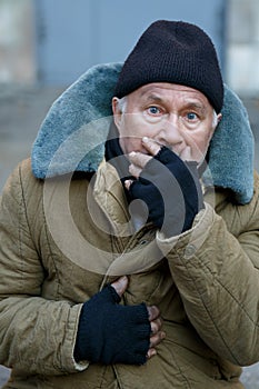 Homeless senior-aged man looks startled an alarmed