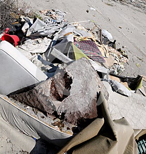 Homeless shelter with broke mattresses and many garbage