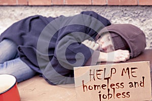 Homeless sleeping on a cardboard