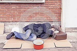 Homeless sleeping on a cardboard