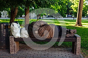 Homeless sleeping on a park bench. Lithuania