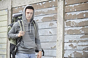 Homeless Teenage Boy On Street With Rucksack